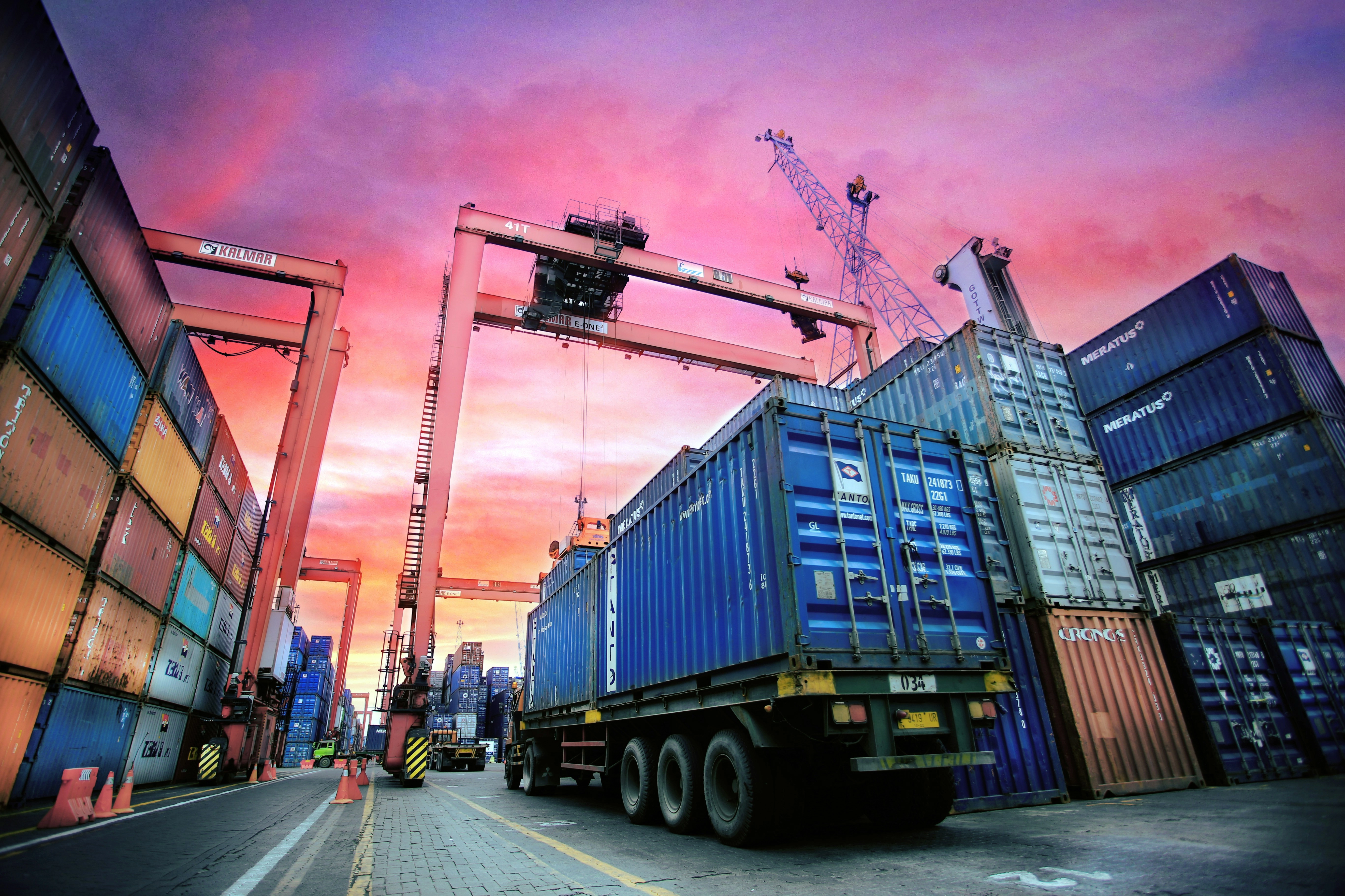 Cargo port with stacked containers at sunset